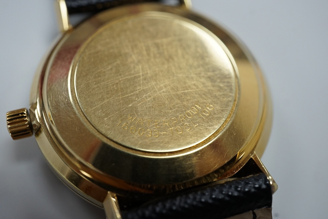 A gentleman's gold plated Omega De Ville automatic wrist watch, with baton numerals and date aperture, case diameter 35mm, on an associated strap, with Omega case.